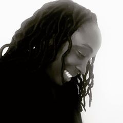 Black and white portrait of Lakisha Harper smiling in profile